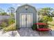 Close up of a shed featuring a cozy bench and stone pavers at 4408 W Lackland Pl, Tampa, FL 33616
