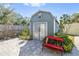 Exterior view of a well-kept shed with a charming red bench at 4408 W Lackland Pl, Tampa, FL 33616