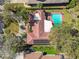 Aerial view of a house featuring a private pool, solar panels, patio furniture, and lush greenery at 4609 W San Miguel St, Tampa, FL 33629
