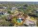 Aerial view of a residential property featuring a private pool, mature trees, and lush landscaping in a suburban setting at 4609 W San Miguel St, Tampa, FL 33629