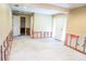 Spacious basement needing renovation with exposed wall studs, concrete flooring, and a doorway to another room at 4609 W San Miguel St, Tampa, FL 33629