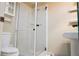 Bathroom features a glass shower, toilet, and pedestal sink at 4609 W San Miguel St, Tampa, FL 33629