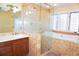 Luxurious bathroom showcasing a glass-enclosed shower, a jetted tub, and a stylish vanity with granite countertop at 4609 W San Miguel St, Tampa, FL 33629