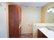 Bathroom features tile floors, tile backsplash, a toilet, and a large brown wood vanity with sink and storage at 4609 W San Miguel St, Tampa, FL 33629