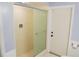 Tiled shower with glass door and neutral walls in this bathroom at 4609 W San Miguel St, Tampa, FL 33629