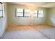 Bright bedroom featuring a large mirror accent wall and natural light from windows at 4609 W San Miguel St, Tampa, FL 33629