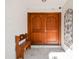 Inviting double front door featuring an arch design, accompanied by a wooden bench and artistic wall decor at 4609 W San Miguel St, Tampa, FL 33629