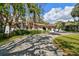Inviting one-story home featuring a red tile roof, beautiful landscaping, and a long driveway with mature shade trees at 4609 W San Miguel St, Tampa, FL 33629