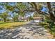 Charming single-story home with a tile roof, a long driveway, mature trees, and meticulously maintained landscaping at 4609 W San Miguel St, Tampa, FL 33629