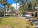 A picturesque single-story residence with a tile roof, lush palms, manicured lawn, and a spacious driveway at 4609 W San Miguel St, Tampa, FL 33629