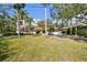 Charming single story home with an arched entrance and a well maintained front yard surrounded by mature trees at 4609 W San Miguel St, Tampa, FL 33629