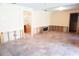 Partially renovated living room with tile flooring, awaiting finishing touches, conveniently located near the bathroom at 4609 W San Miguel St, Tampa, FL 33629