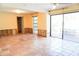 Bright and airy living room with a sliding glass door and windows, ready for renovation at 4609 W San Miguel St, Tampa, FL 33629