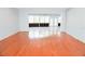Bright living space with hardwood floors, transitioning to a tiled sunroom with large windows at 4609 W San Miguel St, Tampa, FL 33629