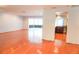 Open living space with hardwood floors, leading to a sunroom and view into a remodeled kitchen area at 4609 W San Miguel St, Tampa, FL 33629