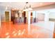 Open-concept living space, featuring hardwood floors, dark wood cabinetry and sunroom in the background at 4609 W San Miguel St, Tampa, FL 33629