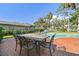 Outdoor brick patio with dining table and chairs, perfect for backyard gatherings at 4609 W San Miguel St, Tampa, FL 33629