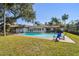 Backyard pool featuring a brick patio with chairs for relaxing by the poolside at 4609 W San Miguel St, Tampa, FL 33629