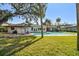 Backyard pool view featuring a lush lawn and mature landscaping at 4609 W San Miguel St, Tampa, FL 33629