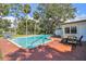 Backyard pool with a brick patio and outdoor dining furniture, perfect for entertaining at 4609 W San Miguel St, Tampa, FL 33629