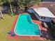 Aerial view of a private pool with brick patio, outdoor furniture, lush landscaping, and a pool house at 4609 W San Miguel St, Tampa, FL 33629
