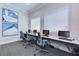 Bright computer room featuring multiple workstations with stylish chairs and modern art at 4868 Marble Springs Cir, Wimauma, FL 33598