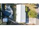 Aerial view of the property showcasing the pool, deck, shed, metal roof, and yard at 5410 Tangerine Dr, Zephyrhills, FL 33542