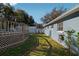 Backyard with the house, part of the deck and landscaping at 5410 Tangerine Dr, Zephyrhills, FL 33542