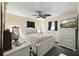 Bright bedroom featuring neutral tones, fan, white furniture, and a television at 5410 Tangerine Dr, Zephyrhills, FL 33542