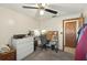 Bright bedroom with white walls and a computer desk setup at 5410 Tangerine Dr, Zephyrhills, FL 33542