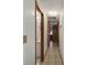 Hallway with tile flooring and multiple doorways leading to different rooms at 5410 Tangerine Dr, Zephyrhills, FL 33542