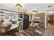 Bright kitchen area with a wooden table, black refrigerator, and neutral tile flooring at 5410 Tangerine Dr, Zephyrhills, FL 33542