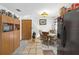Kitchen featuring wooden cabinets, black appliances, and neutral tile floors at 5410 Tangerine Dr, Zephyrhills, FL 33542