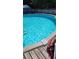 Relaxing backyard pool featuring clear blue water and a charming sundeck, perfect for recreation at 5410 Tangerine Dr, Zephyrhills, FL 33542