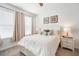 Bright bedroom features neutral decor, a ceiling fan, and plenty of natural light from two large windows at 5566 Silver Sun Dr, Apollo Beach, FL 33572