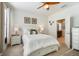Inviting bedroom with a queen bed, two side tables, and an open door to the bathroom at 5566 Silver Sun Dr, Apollo Beach, FL 33572