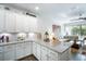 Bright kitchen features white cabinets, granite countertops, and opens to the living room at 5566 Silver Sun Dr, Apollo Beach, FL 33572