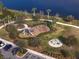 Aerial view of a neighborhood playground with a swing set, slides, climbing structure, and lush landscaping at 5566 Silver Sun Dr, Apollo Beach, FL 33572