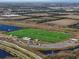 An aerial view shows a large multi-purpose sports field with a small splashpad play area and parking at 5566 Silver Sun Dr, Apollo Beach, FL 33572