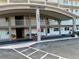 Exterior shot of the building entrance featuring a covered walkway and manicured landscaping at 5980 Shore S Blvd # 510, Gulfport, FL 33707