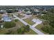 Aerial view of a one-story home with a long driveway in a treed neighborhood at 6160 Van Dine St, Englewood, FL 34224