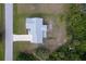 Aerial view of a well-maintained home with a long driveway, surrounded by lush greenery and landscaping at 6160 Van Dine St, Englewood, FL 34224