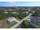 Aerial view of a one-story home with a long driveway in a treed neighborhood at 6160 Van Dine St, Englewood, FL 34224