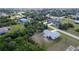 Overhead shot of the house surrounded by green trees in a well-maintained neighborhood at 6160 Van Dine St, Englewood, FL 34224