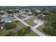 Aerial view of a one-story home with a long driveway in a treed neighborhood at 6160 Van Dine St, Englewood, FL 34224
