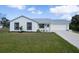 Charming home featuring a well-maintained lawn and a bright, freshly painted exterior at 6160 Van Dine St, Englewood, FL 34224