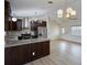 Well-equipped kitchen featuring stainless steel appliances, a granite island, and a seamless flow into the adjacent living spaces at 6160 Van Dine St, Englewood, FL 34224