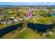 Aerial view of home on golf course and lake surrounded by lush greenery at 7009 Greenbrier Dr, Seminole, FL 33777