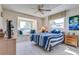 Bedroom with blue accents, comfortable bed, and a bright window seat at 7009 Greenbrier Dr, Seminole, FL 33777