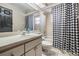 Clean bathroom featuring vanity, sink, toilet, and shower/tub with black and white patterned curtain at 7911 Floradora Dr, New Port Richey, FL 34654